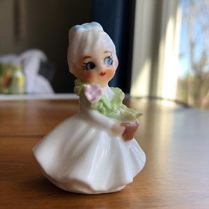 Vintage miniature porcelain girl figurine with flowers